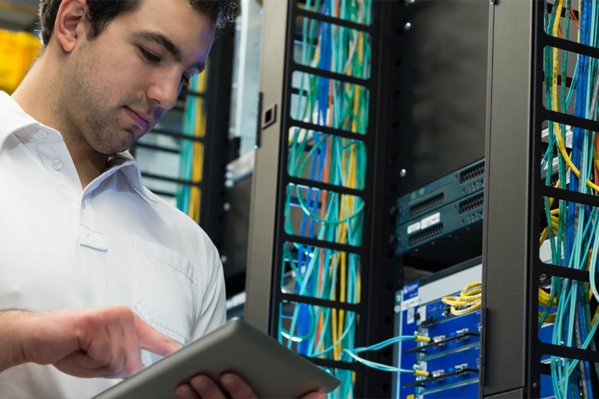 onsite-response Man in server center making an adjustment with a tablet