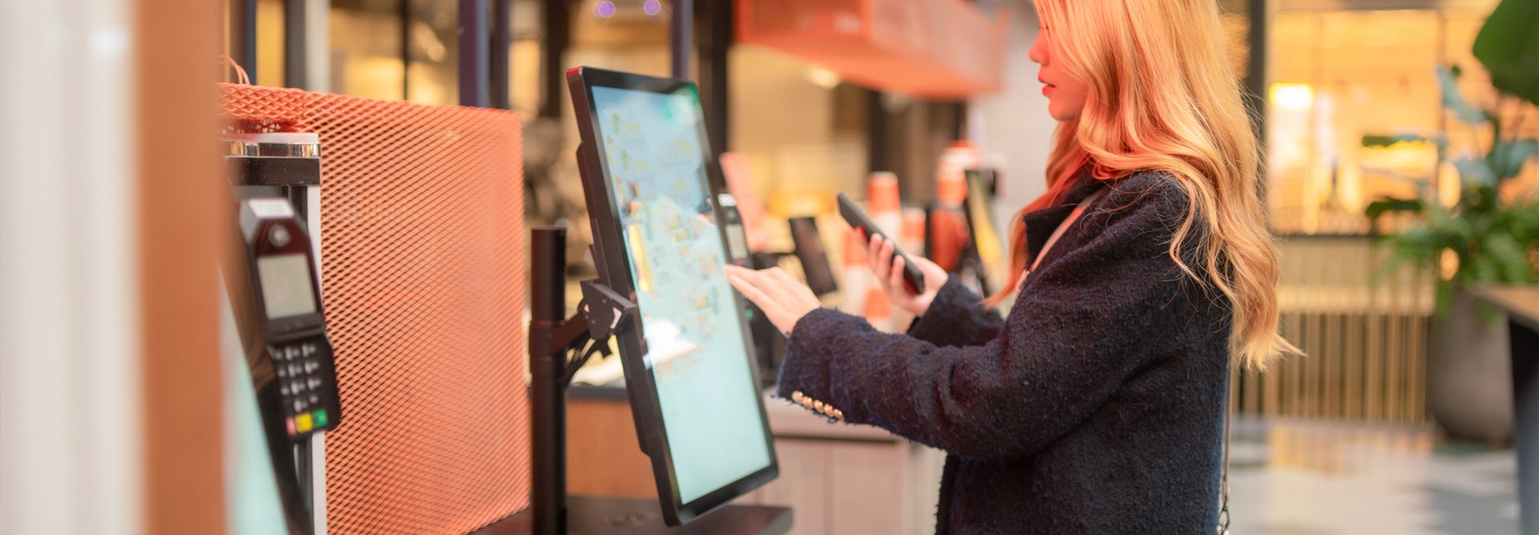 Woman operating kiosk